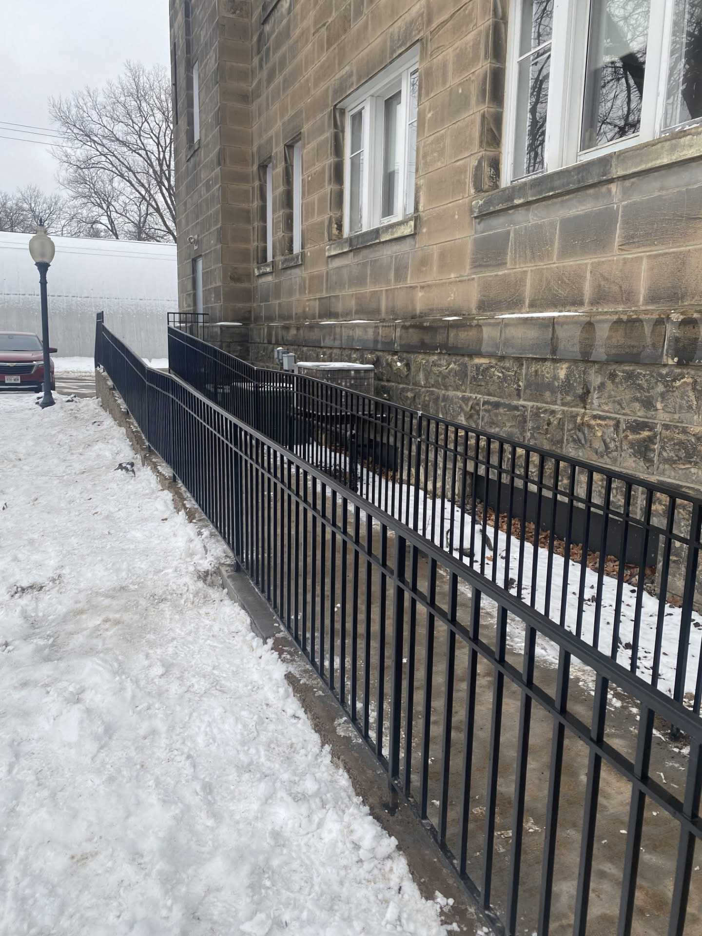 An accessible wheelchair ramp with railings at the Colfax Municipal Building.