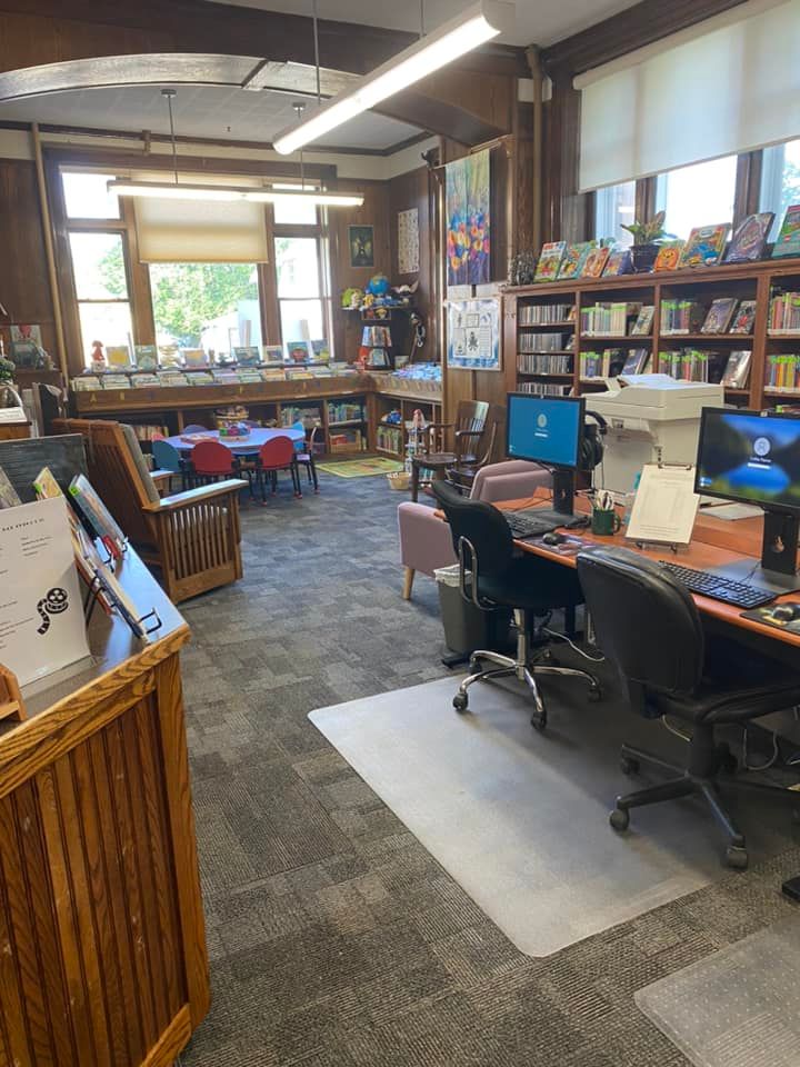 Photo of inside of the library with bookshelves and computers.
