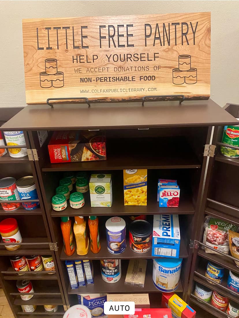 Little free pantry cabinet with canned and boxed food items.